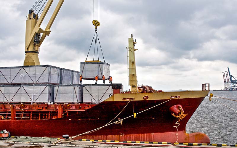 The worker loads the cargo ship after passing the criteria for IC-DISC.