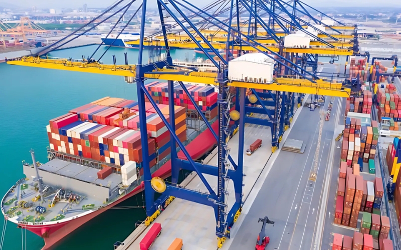 A large container ship docked at a port, symbolizing global trade and industry-specific insights for domestic and international sales.